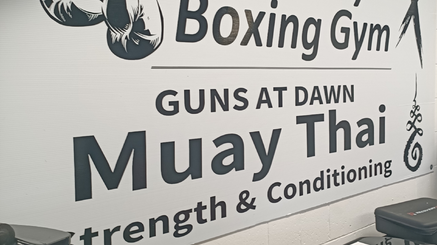 The Guns At Dawn Muay Thai, Strength and Conditioning banner on the gym wall