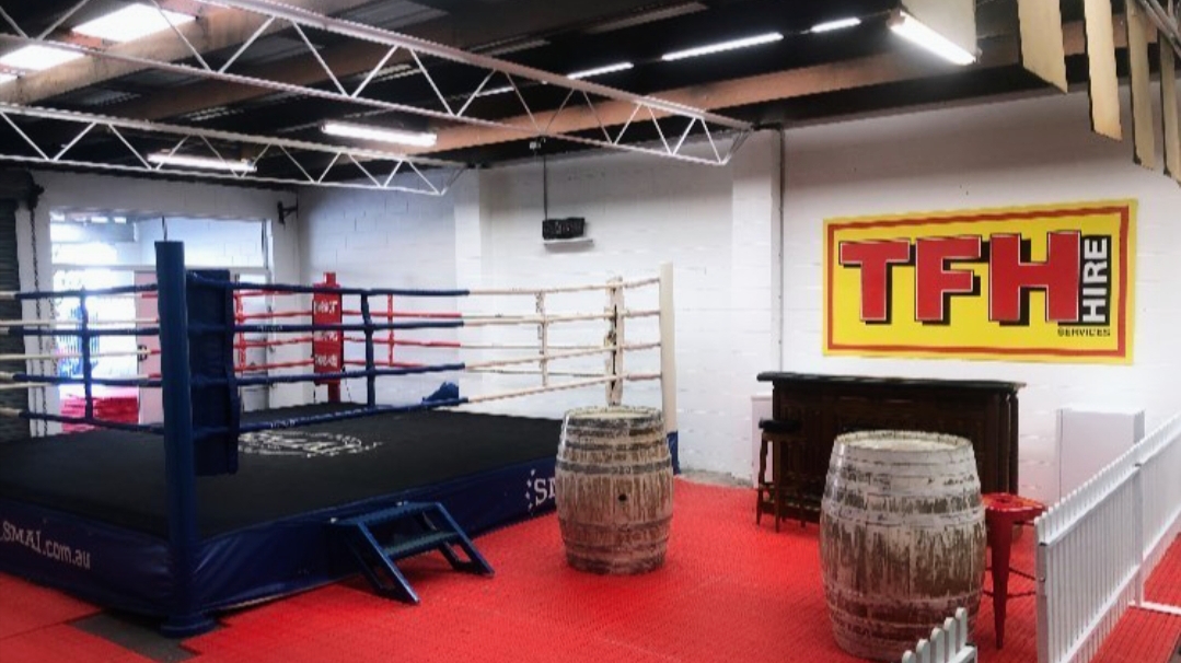 The boxing ring and the bar area inside the gym